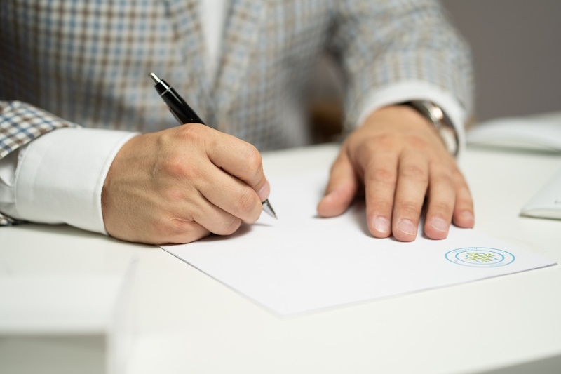 Someone writing on a piece of paper