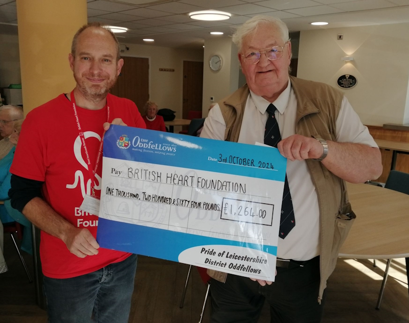 Handing over the donation with a big cheque to the BHF