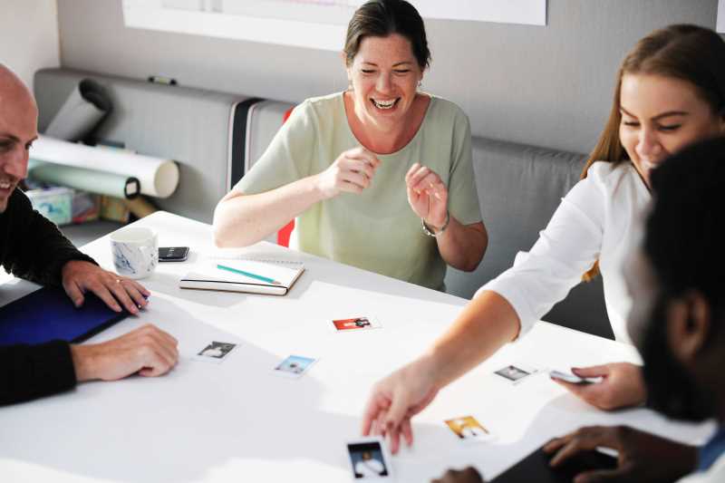 Four people sat round a table looking at photos taking part in market research