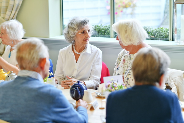 5 members enjoying an afternoon tea together.