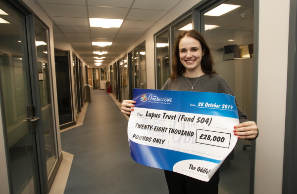 Lupus Trust Research Team PhD student Bekki Velounias with the cheque