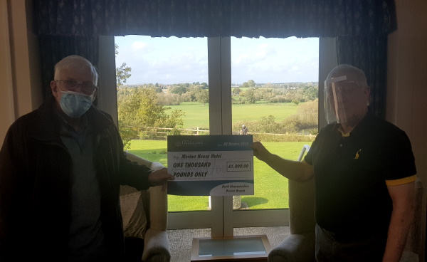 Oddfellows representative presenting cheque to Manager at Merton House.