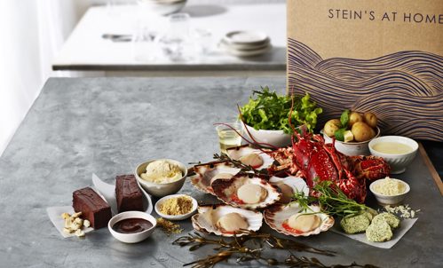 Contents of the Steins at Home Lobster Box on display - lobsters, scallops, potatoes, salad, chocolate pave and dips and butter