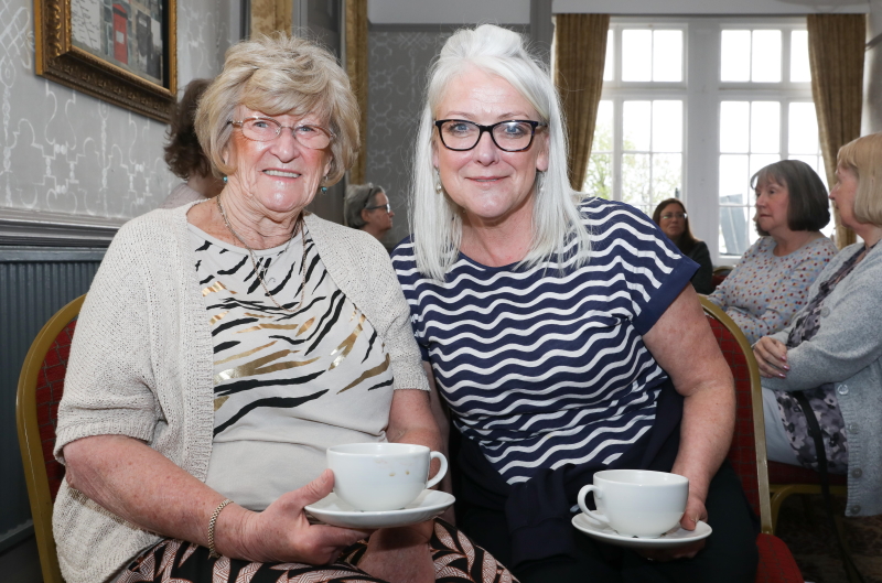 Val Rider sat having a cup of tea with an Oddfellows Social Organiser Angela