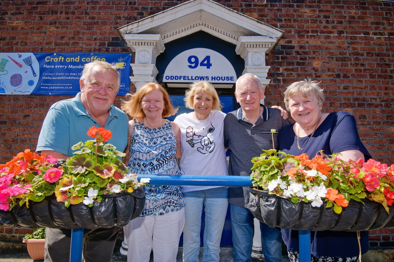Vera stading fanked by four friends outside Bury's Oddfellows Hall