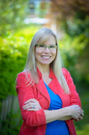 Headshot of Dr Jennifer Wild. She is stood with crossed arms and smiling to the camera