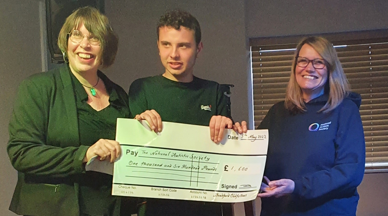 3 representatives from the charity and the Oddfellows stood holding a big cheque.