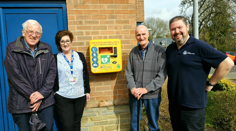 People stood next to defibrillator
