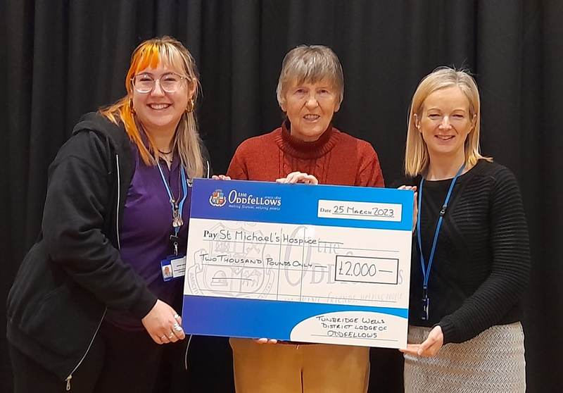 Three women smile at the camera and hold a large cheque between them. Pictured from left to right are Sophie Bailey, Margaret Walisko, and Rebecca Futrall