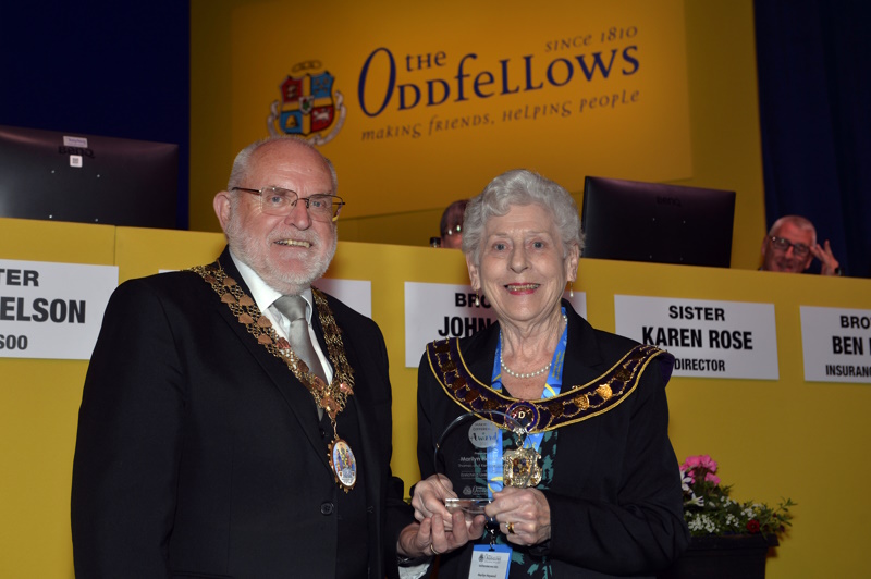 Marilyn being presented with her trophy on stage with Grand Master David Ogden