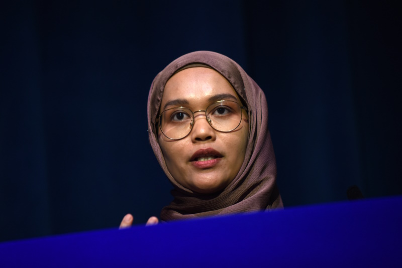 A close up of Nur Zainal speaking to the conference