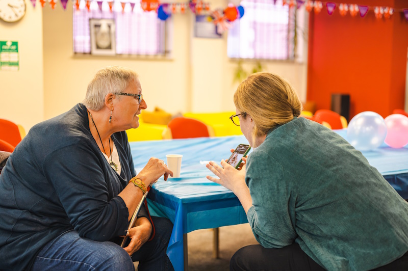 Two people looking at a phone screen