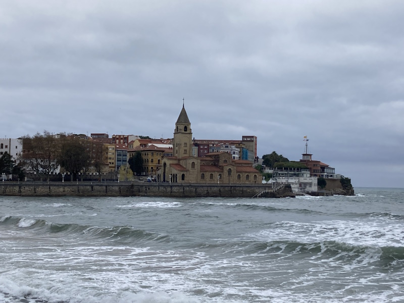 A church dominates the skyline in the background with the sea on the foreground