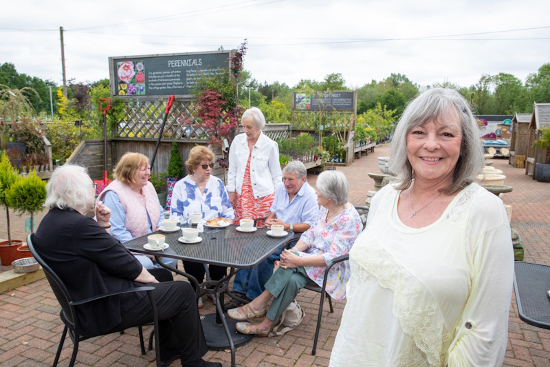 A group of members sat round a table at an event based at a local garden centre