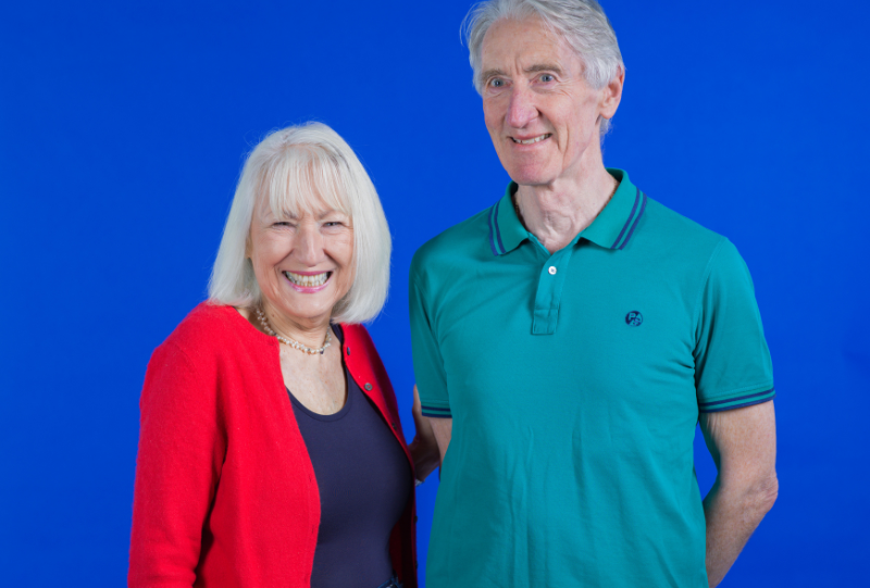 Members Andrea and John stood together smiling