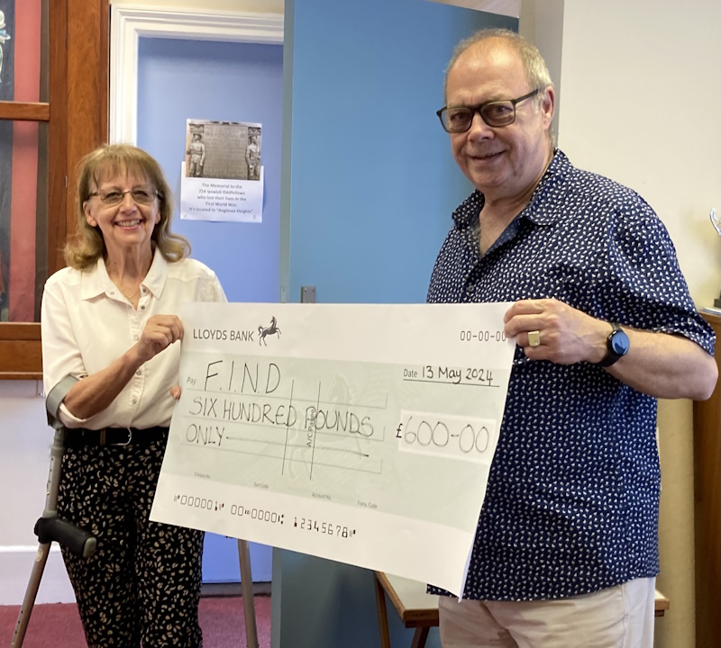 Two people holding a large cheque