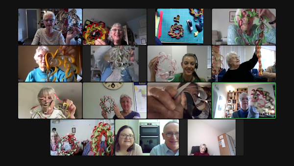 Lots of people enjoying an online event where they show off the paper heart decorations they crafted
