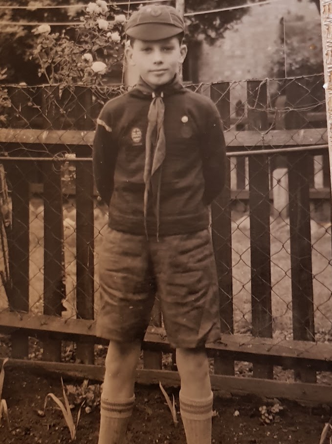 A boy wearing a scout uniform