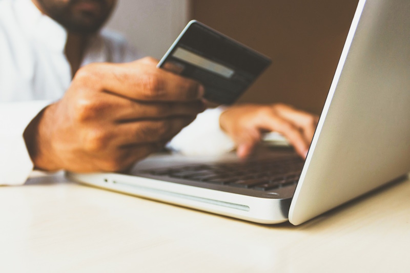 Someone using a credit card to make an online payment