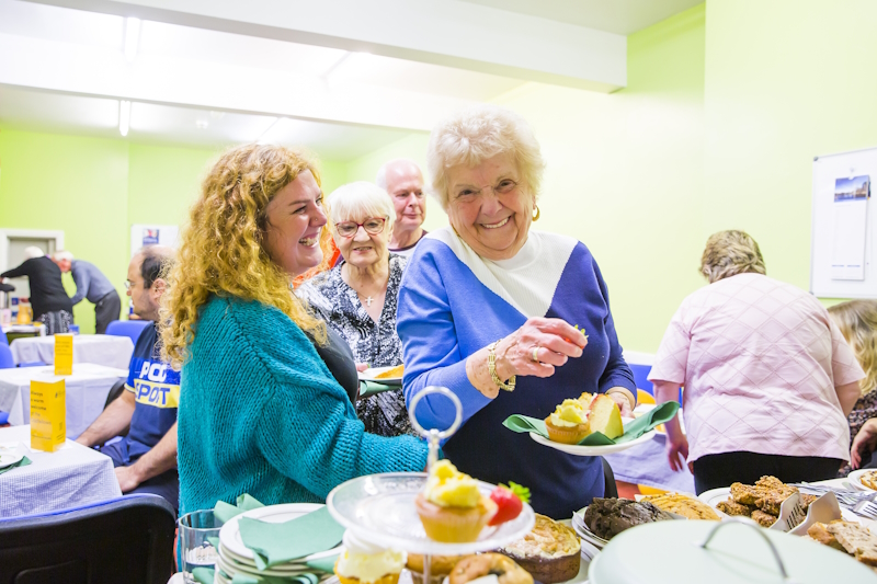 Members at Halifax Oddfellows enjoying a home made cake event at their hall. Liots of smiling members
