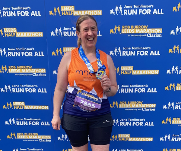 Claire smiles holding a medal