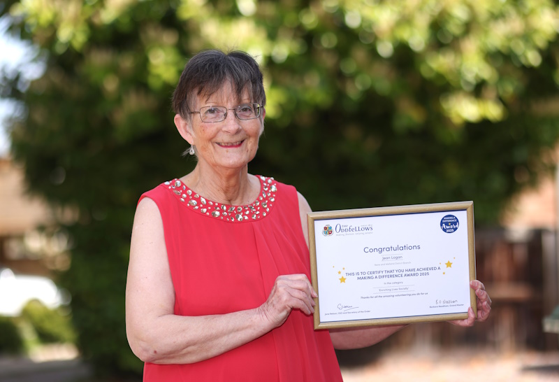 Jean Logan with a certificate