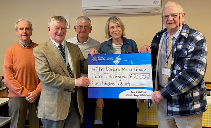 Representatives handing over a big cheque to the charity