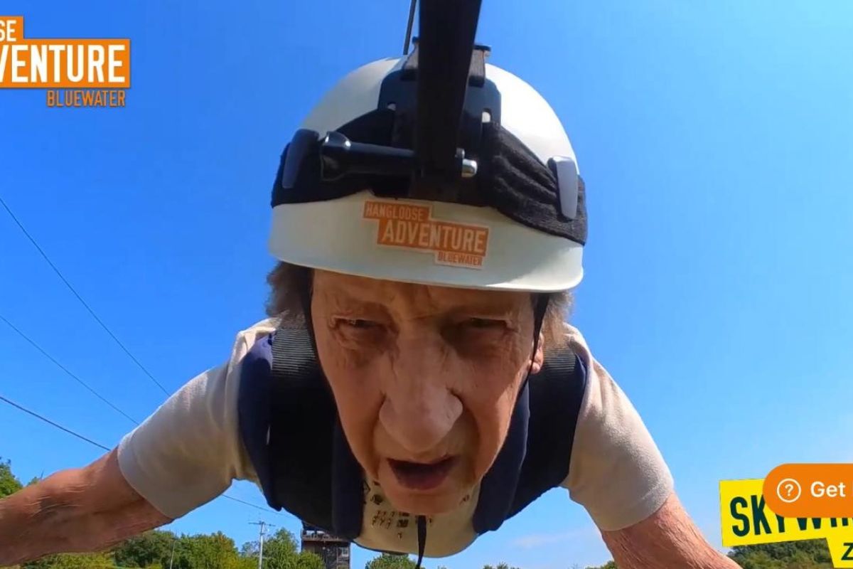 A close up of Gwen's face as she's going down a zipwire