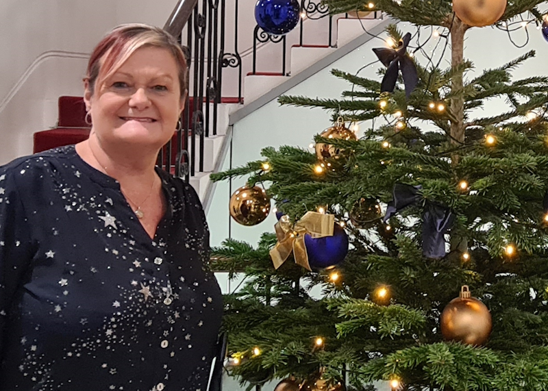Jane Nelson stood next to a Xmas tree