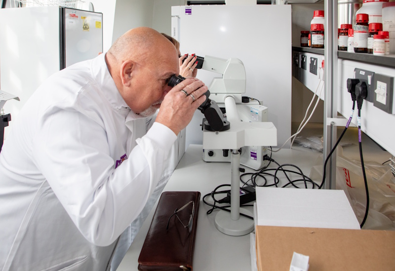 A man looking into a microscope