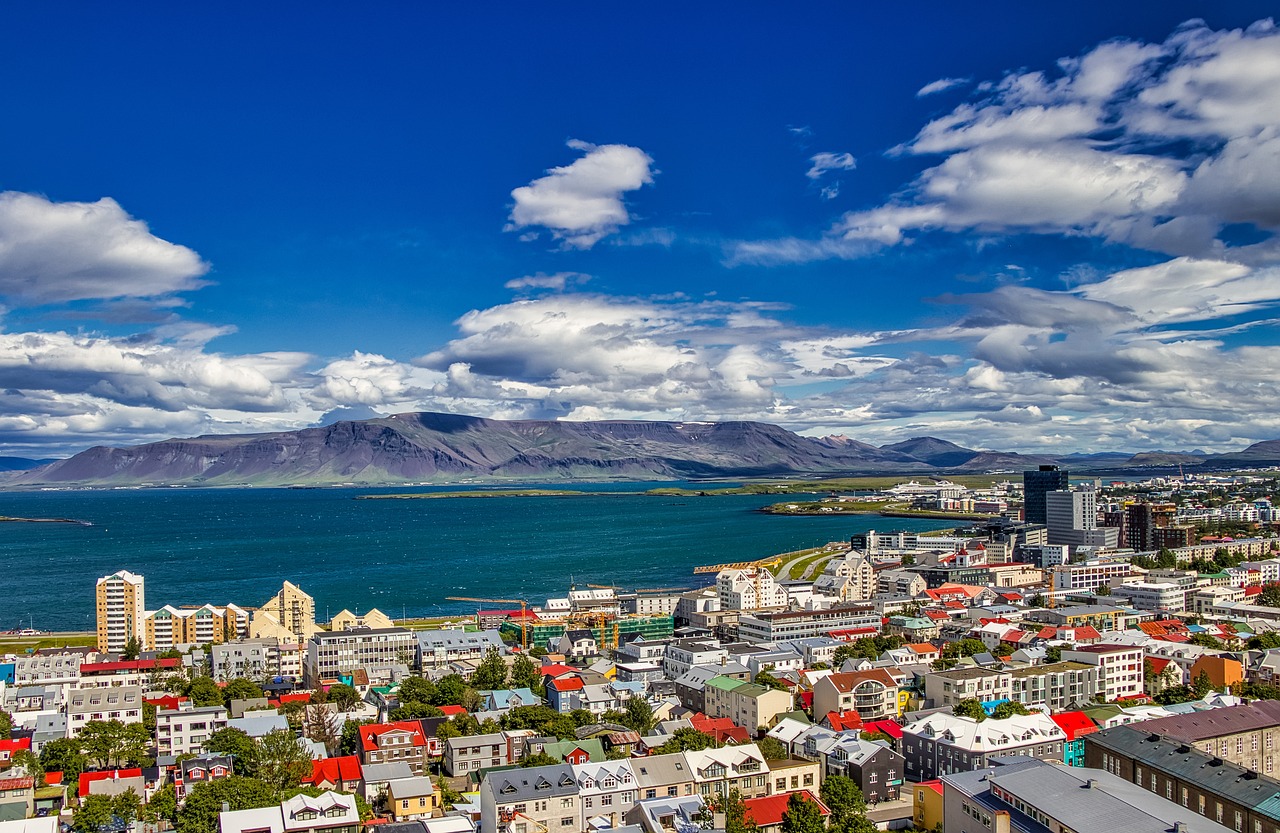 An aerial shot of Iceland's capital city of Reykjavik, looking out to the mountains and water