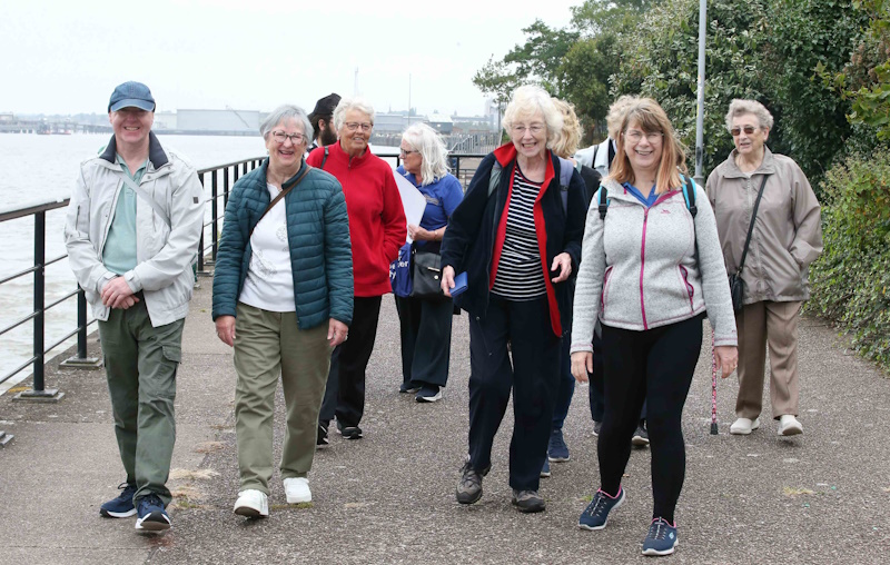 A group of people walking and smiling