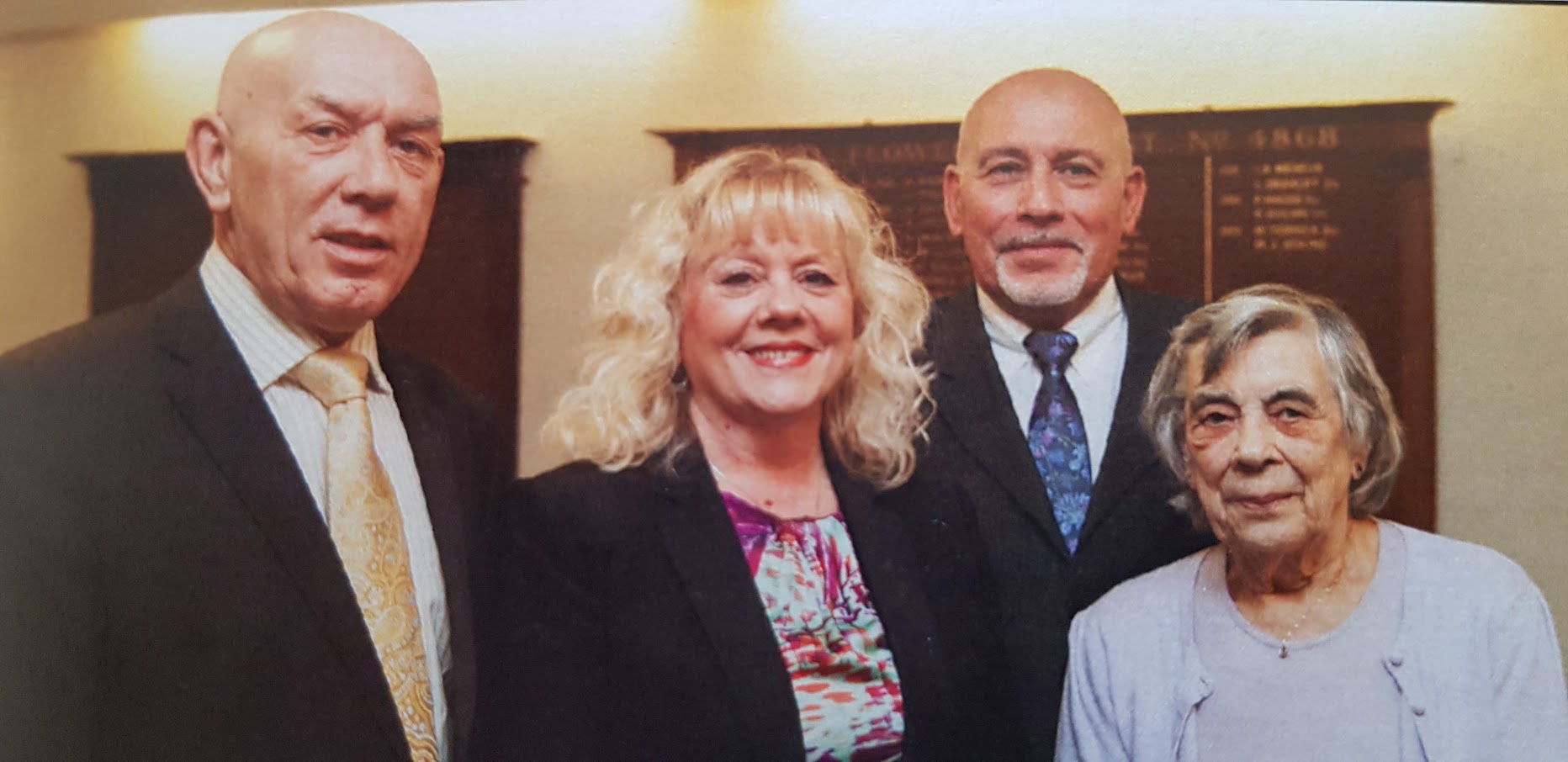 Four people looking towards the camera