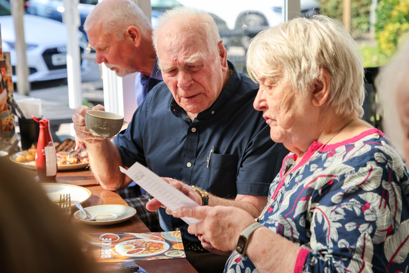 A man and a woman read a menu together