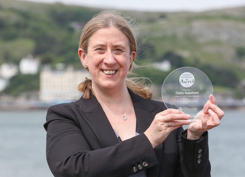 Claire smiling with her award
