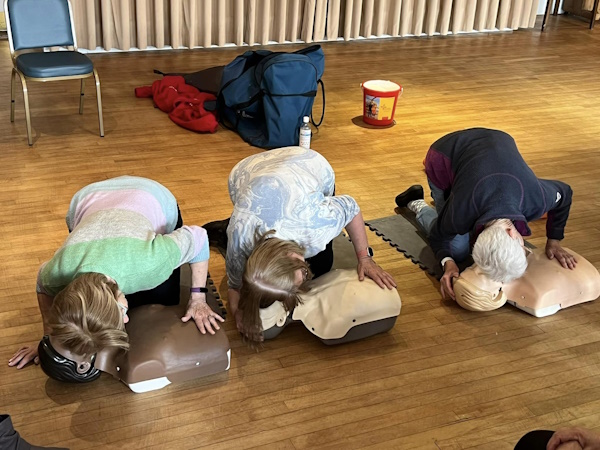 Three women practising CPR on dummies